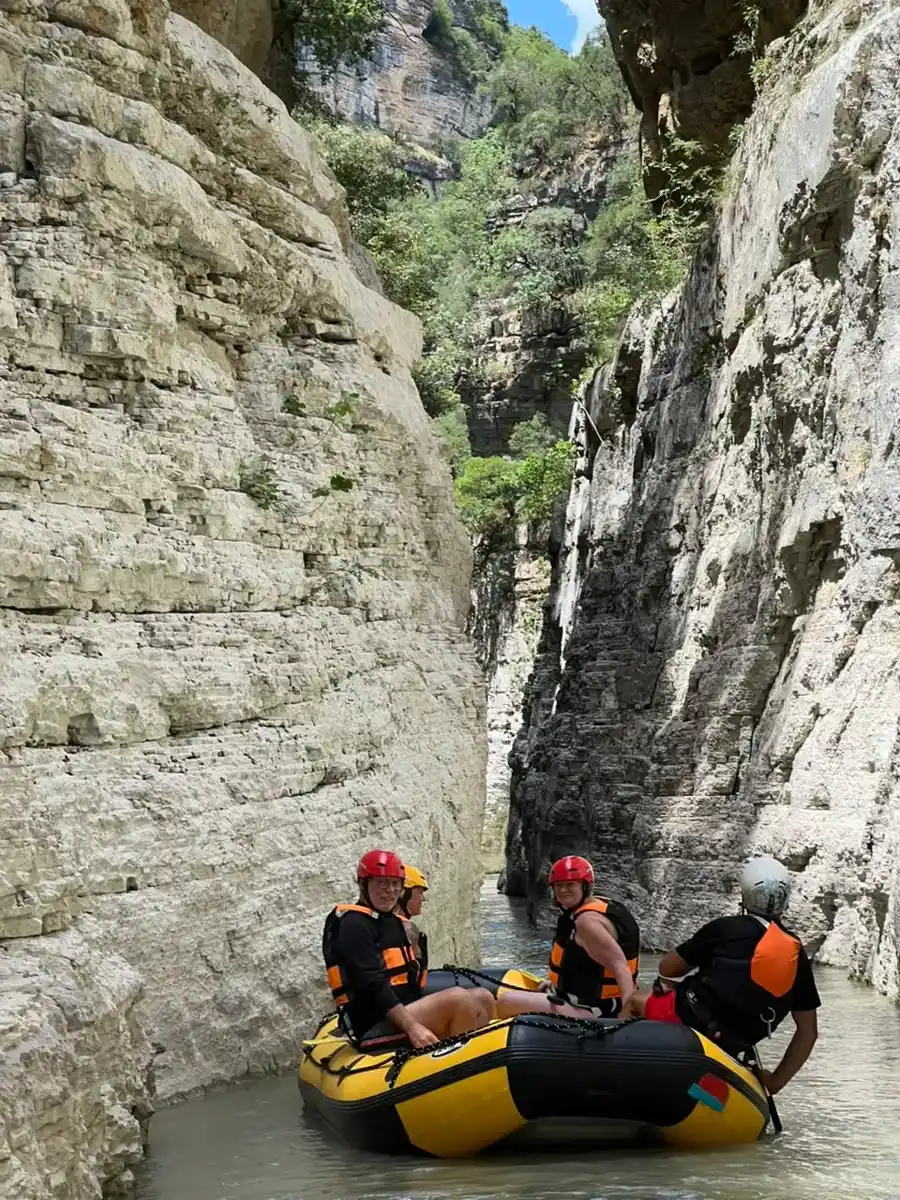 Guide and rafters in red helmets on a yellow raft in Osum Canyon