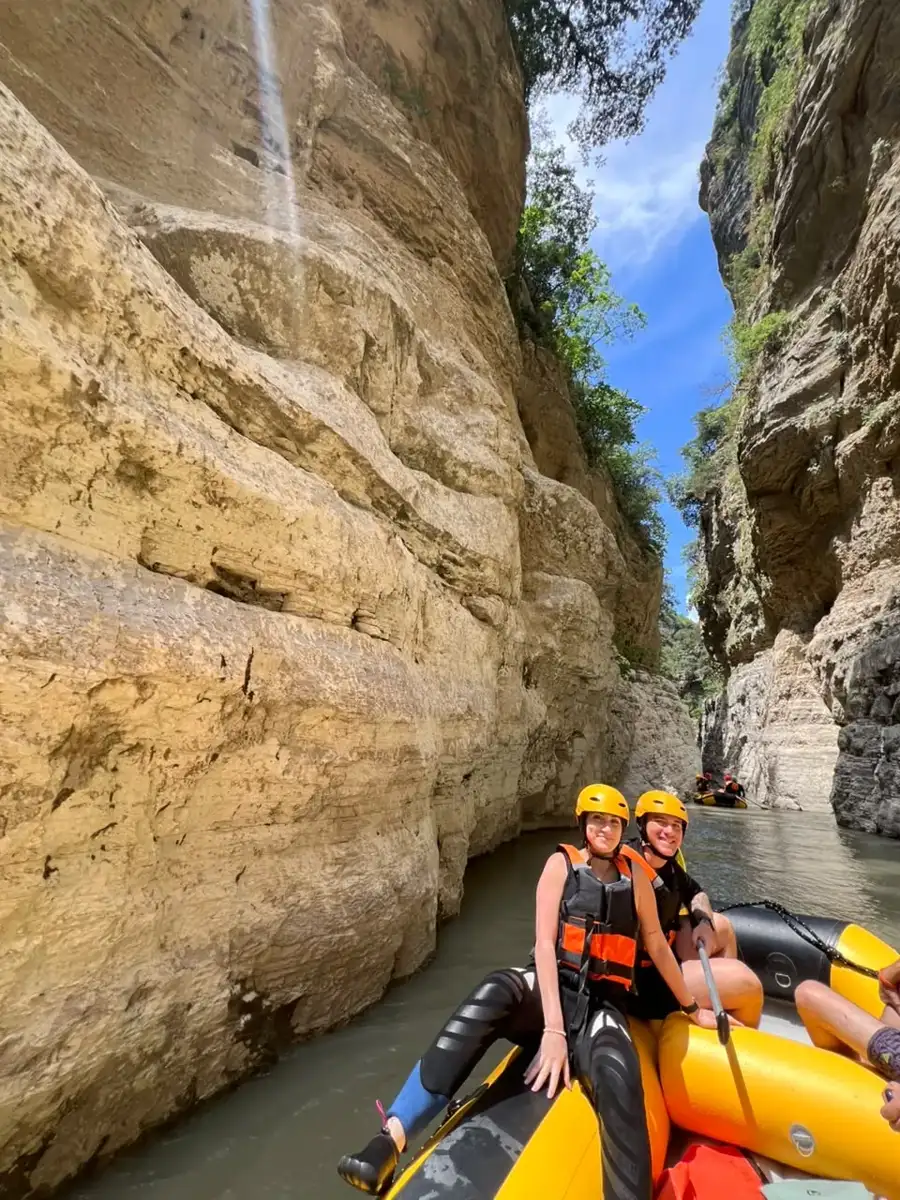Two rafters resting against golden canyon walls